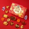 Close-up of XuFuJi 龙马送福 Gift Box snacks – 凤梨酥, 沙琪玛, Milo biscuits, gummies, and more 年货零食